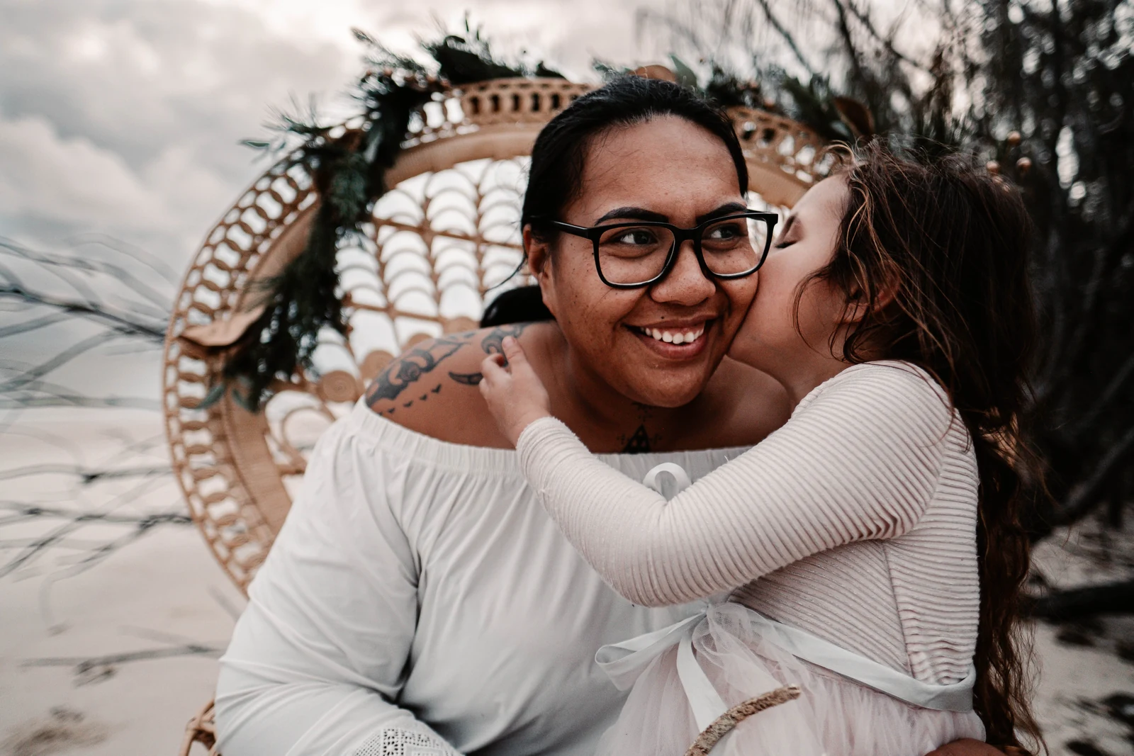 Daughter kissing mum on her cheek