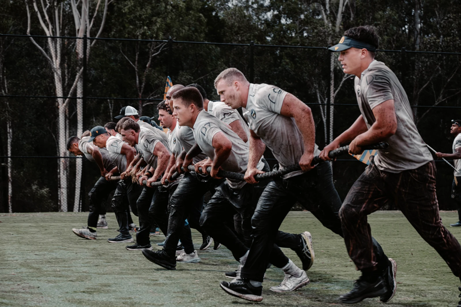 Parramatta Eels players running with heavy rope